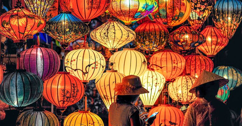 Cultures - Two Person Standing Near Assorted-color Paper Lanterns
